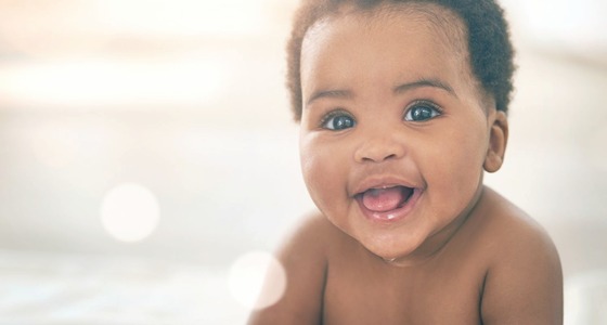 Smiling child, representing early communication and language development