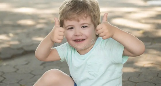 Happy young student giving thumbs up after speech therapy progress